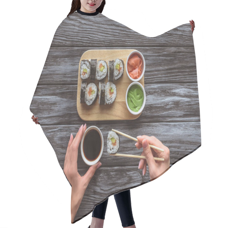 Personality  Cropped Shot Of Person Holding Chopsticks And Eating Delicious Sushi Roll  Hair Cutting Cape