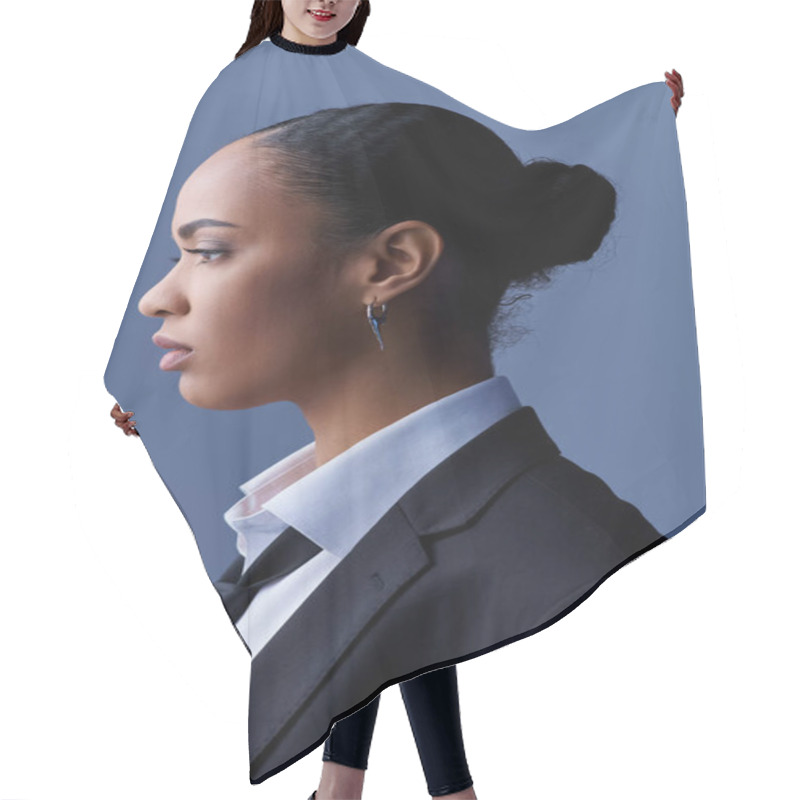 Personality  Young African American Woman In A Suit And Tie Gazes Thoughtfully To The Side. Hair Cutting Cape