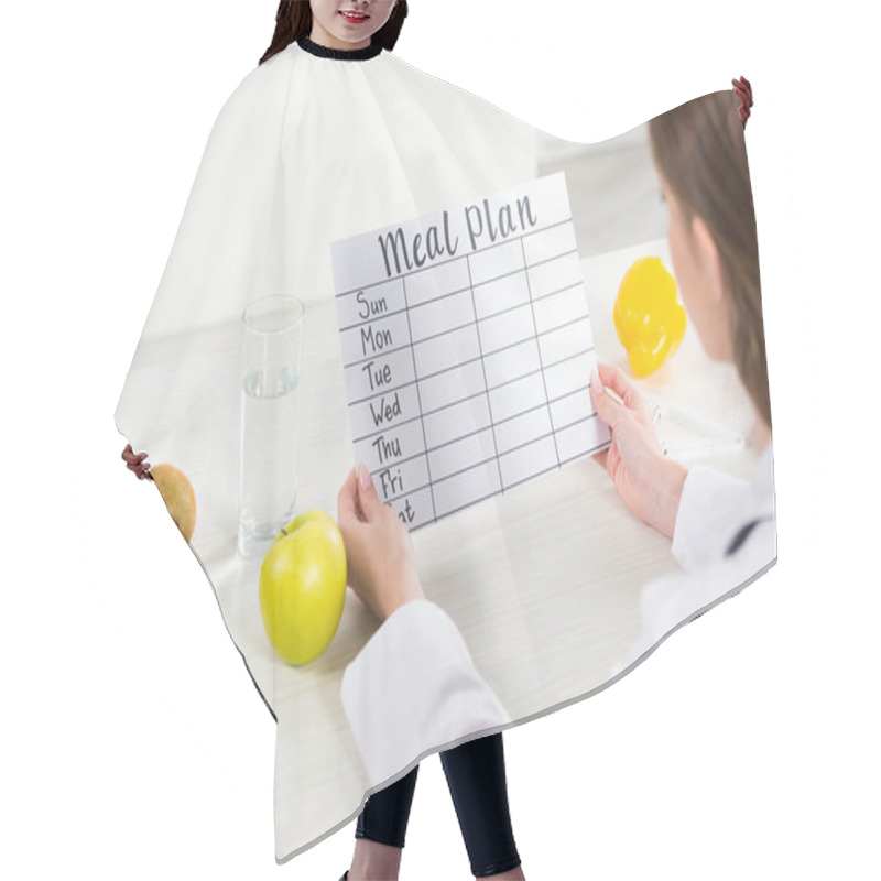 Personality  Cropped View Of Dietitian In White Coat Holding Meal Plan At Workplace Hair Cutting Cape