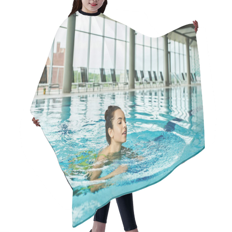 Personality  A Young Brunette Woman In A Swimsuit Gracefully Swimming In A Large Indoor Swimming Pool. Hair Cutting Cape