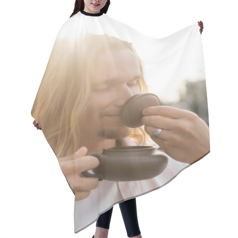 Personality  Pleased Long Haired Man With Closed Eyes Holding Oriental Teapot And Enjoying Flavor Of Puer Tea In Sunshine Outdoors Hair Cutting Cape