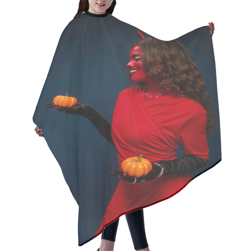 Personality  The Beautiful Woman Dressed As A Devil Joyfully Presents Pumpkins, Celebrating Halloween Spirit. Hair Cutting Cape