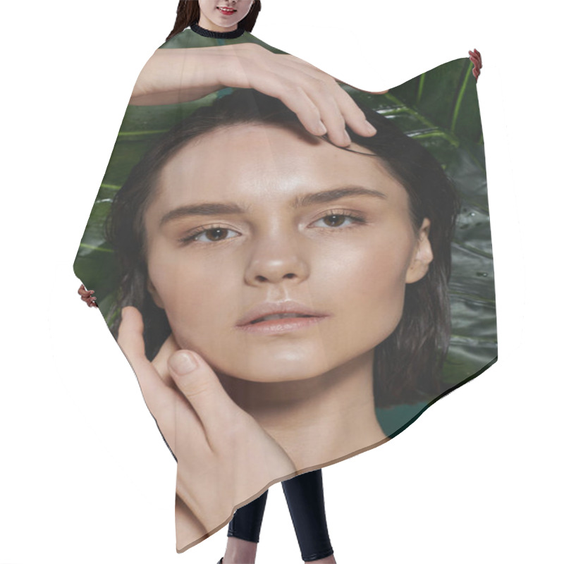 Personality  A Woman With Dark Hair Poses Amongst Vibrant Green Foliage. Hair Cutting Cape