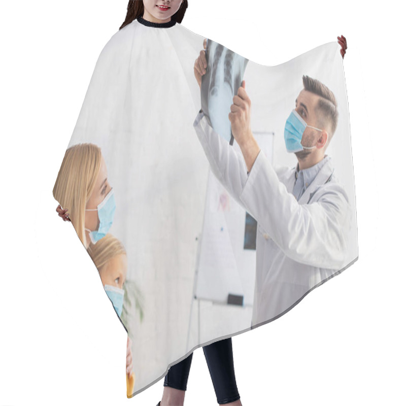 Personality  Pediatrician In Medical Mask Looking At Fluorography Near Mother And Patient  Hair Cutting Cape