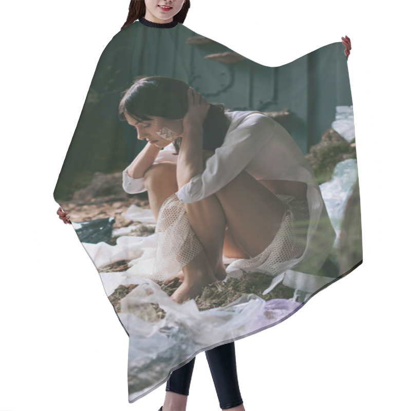 Personality  A Woman In A White Shirt Sits In A Forest Clearing, Surrounded By Plastic Waste. Hair Cutting Cape