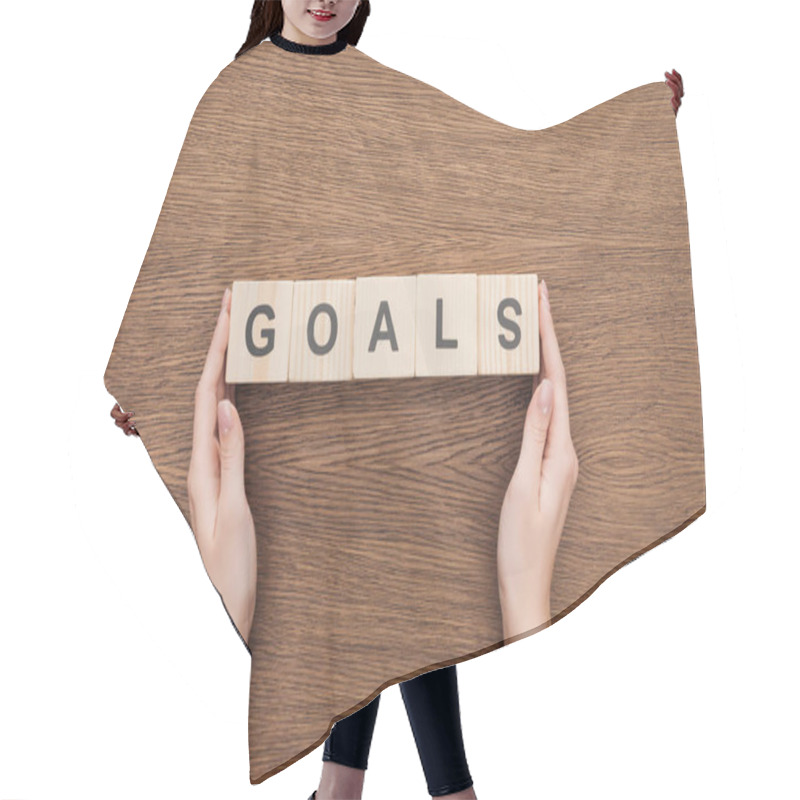 Personality  Partial View Of Person Holding 'goals' Word Made Of Wooden Blocks On Wooden Tabletop, Goal Setting Concept Hair Cutting Cape