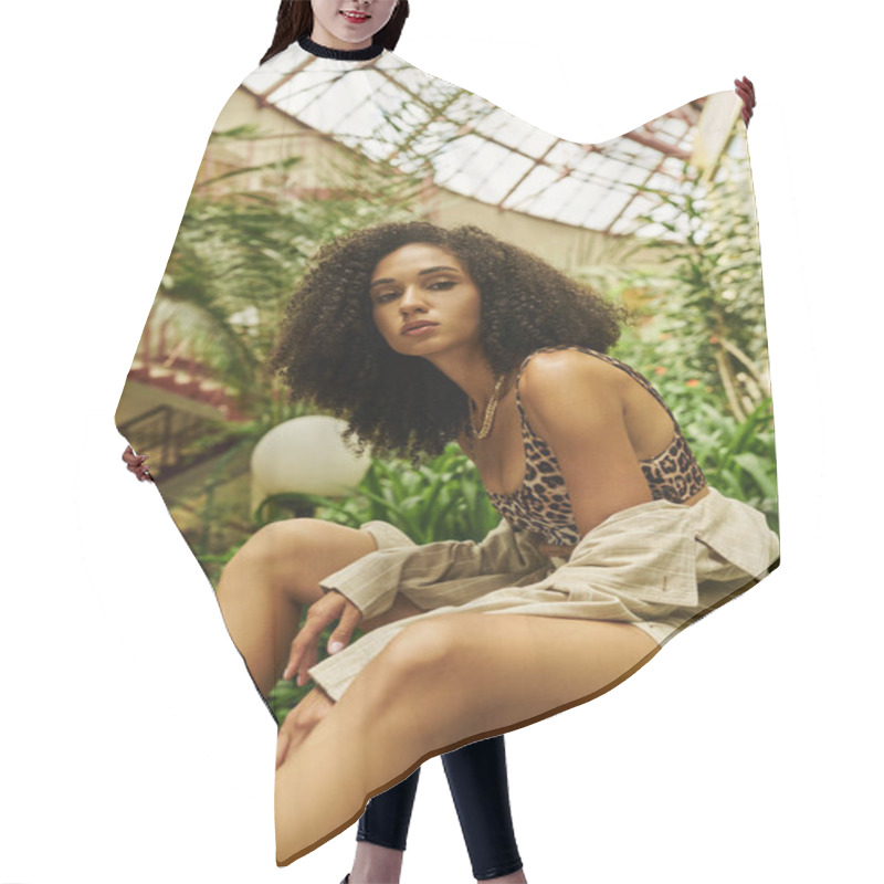 Personality  Young African American Woman With Curly Hair Posing In Her Trendy Look In A Botanical Setting Hair Cutting Cape