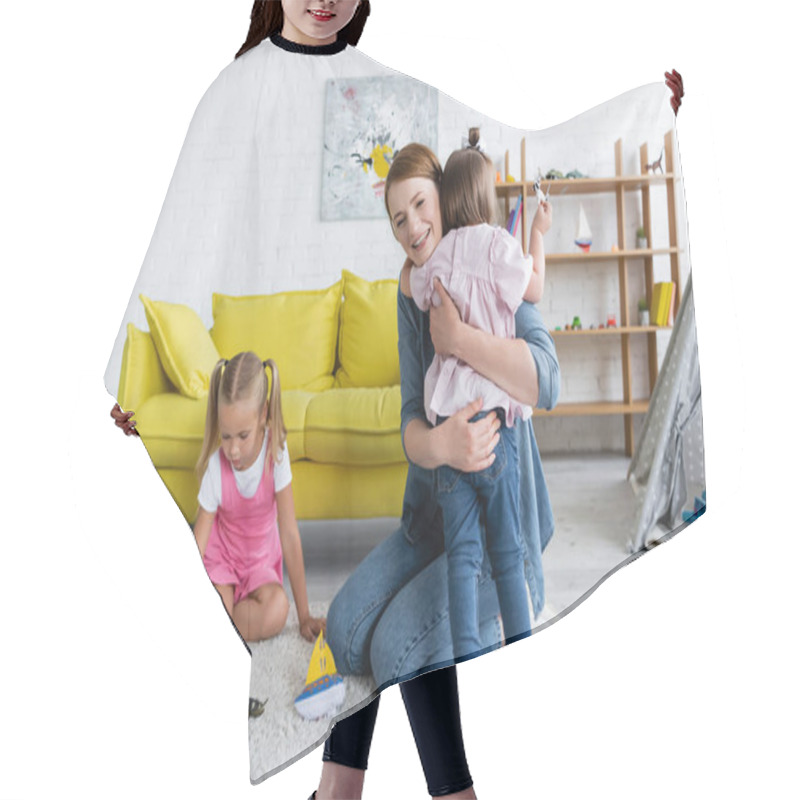 Personality  Happy Kindergarten Teacher Hugging Toddler Girl With Down Syndrome Near Preschooler Child Playing With Toys In Playroom  Hair Cutting Cape