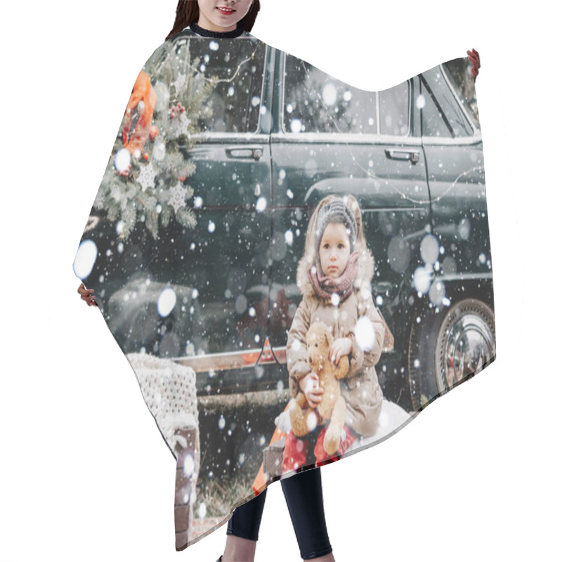 Personality  Little Attractive Girl Dressed In Winter Jacket Standing In Front Of Retro Car Decorated For New Year During Snowfall Hair Cutting Cape