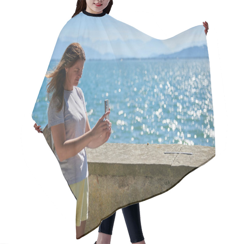 Personality  Woman Capturing Scenic Photos By A Sparkling Lake On A Sunny Day With Majestic Mountain Views. Idyllic Lakeside Setting Showcases Natural Beauty And Outdoor Adventure In A Serene European Landscape Hair Cutting Cape