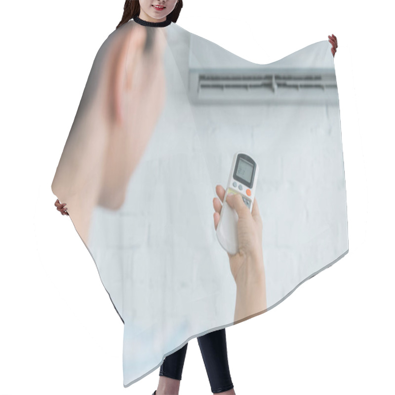 Personality  Selective Focus Of Woman With Remote Control  Turning On Air Conditioner   Hair Cutting Cape