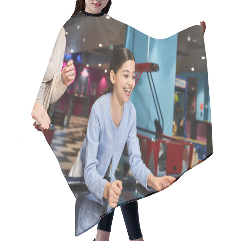 Personality  A Mother And Daughter Enthusiastically Play A Game Of Air Hockey, Immersed In Laughter And Competitiveness At A Mall Gaming Zone. Hair Cutting Cape