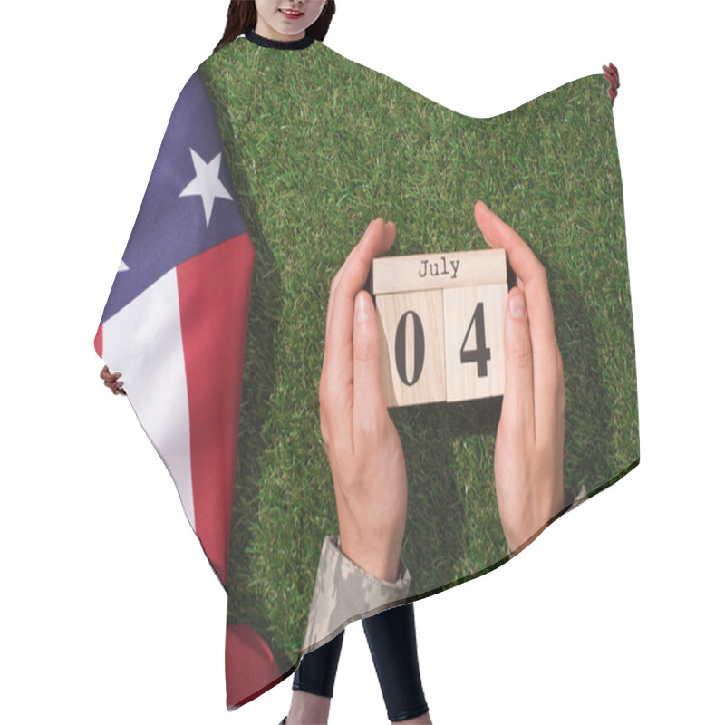 Personality  Cropped Shot Of Soldier In Military Uniform Holding Calendar With 4th July Date With American Flag On Green Grass, Americas Independence Day Concept Hair Cutting Cape