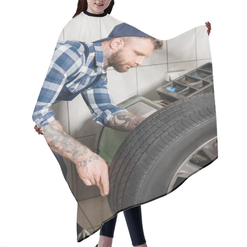 Personality  Young Repairman Examining Wheel On Balance Control Equipment Hair Cutting Cape