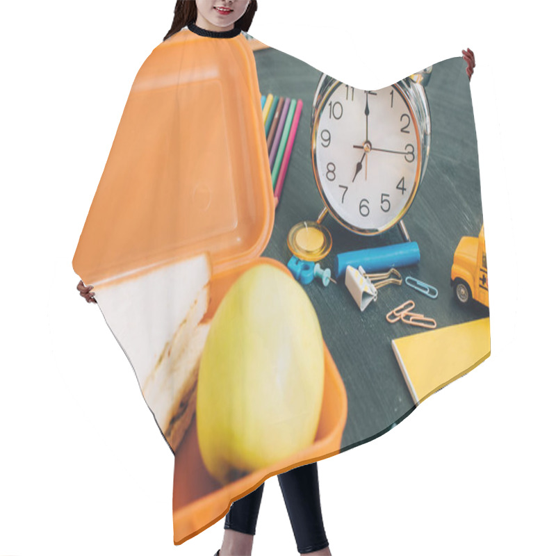 Personality  Selective Focus Of Lunch Box With Tasty Sandwiches And Ripe Apple Near Vintage Alarm Clock And School Supplies On Black Chalkboard Hair Cutting Cape