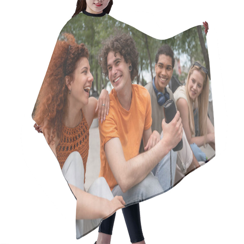 Personality  Happy Young Man Holding Portable Music Speaker Near Interracial Friends Hair Cutting Cape