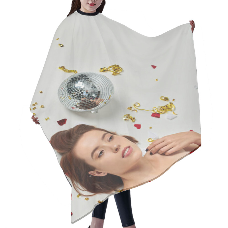 Personality  New Year Party, Young Brunette Woman Lying On Floor Near Confetti And Disco Ball On Grey Backdrop Hair Cutting Cape