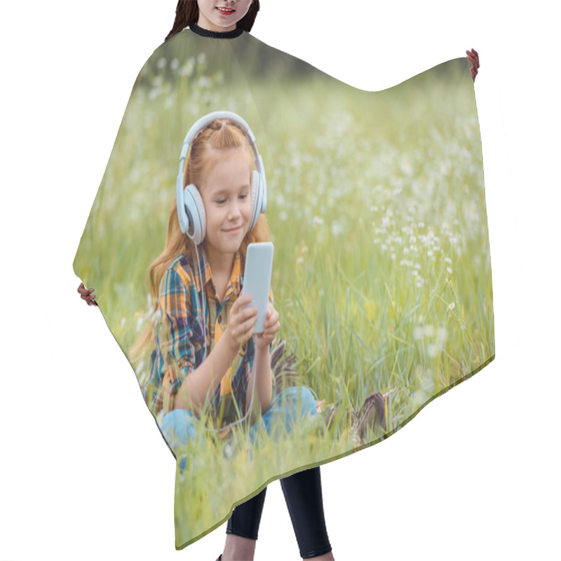 Personality  Smiling Child In Headphones Using Smartphone While Resting On Blanket In Meadow With Wild Flowers Hair Cutting Cape