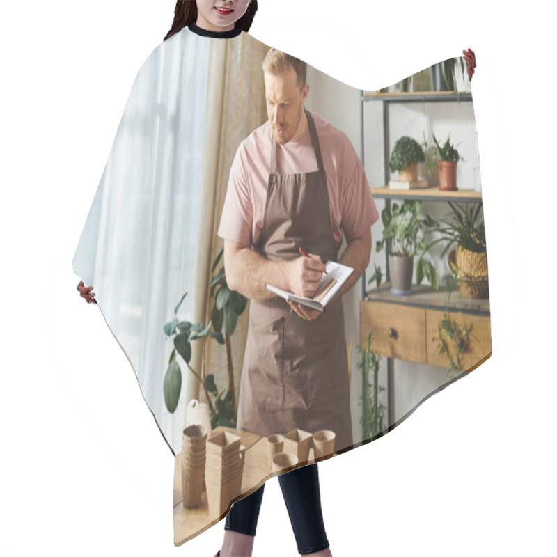 Personality  A Man In An Apron Diligently Takes Notes On A Clipboard In A Plant Shop, Showcasing His Dedication To His Small Business. Hair Cutting Cape