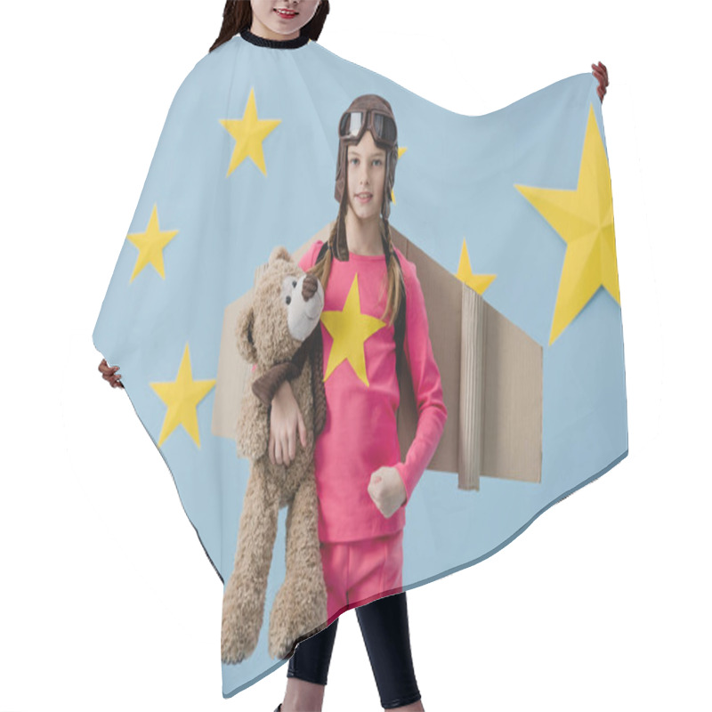 Personality  Child With Cardboard Wings Holding Teddy Bear On Blue Background With Stars Hair Cutting Cape