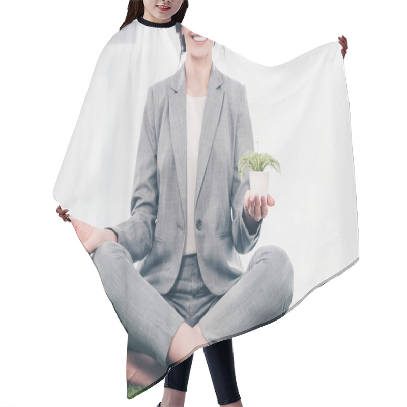 Personality  Cropped View Of Smiling Businesswoman In Suit Meditating On Grass Mat In Lotus Pose With Flowerpot  Hair Cutting Cape