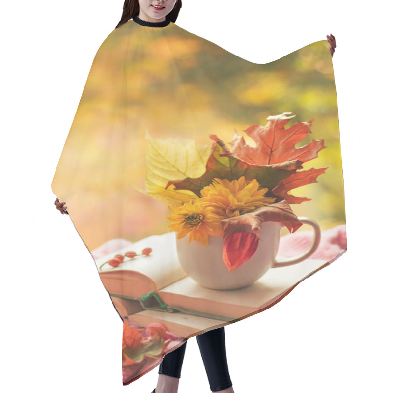 Personality  Autumn Background. A Bouquet Of Autumn Leaves And Flowers In A Cup On An Open Book On A Bright Blurred Background. Season Of Learning And Knowledge. Hair Cutting Cape