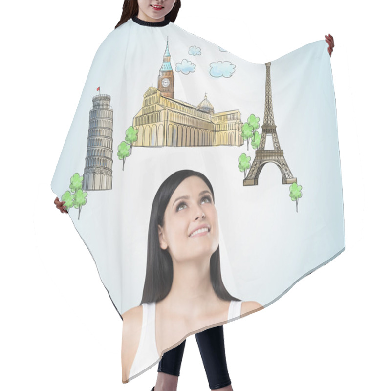 Personality  A Beautiful Brunette Is Looking Up By Dreaming About The Visiting Of The Most Famous European Cities. The Concept Of Tourism And Sightseeing. Light Blue Background. Hair Cutting Cape