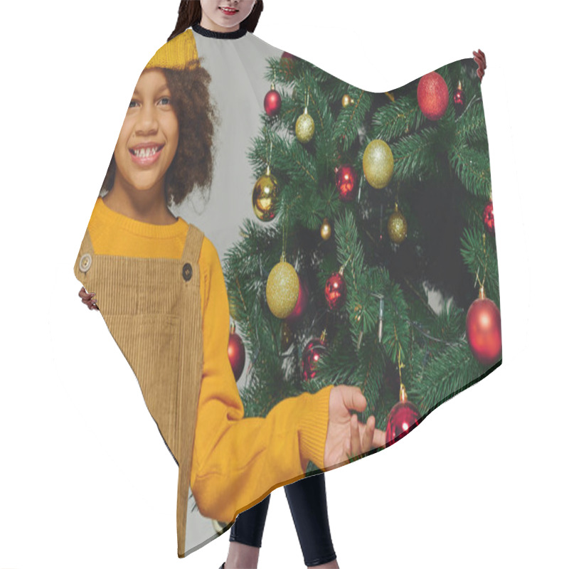 Personality  A Cheerful Girl Adds Decorations To A Christmas Tree, Capturing The Spirit Of The Holiday Season. Hair Cutting Cape