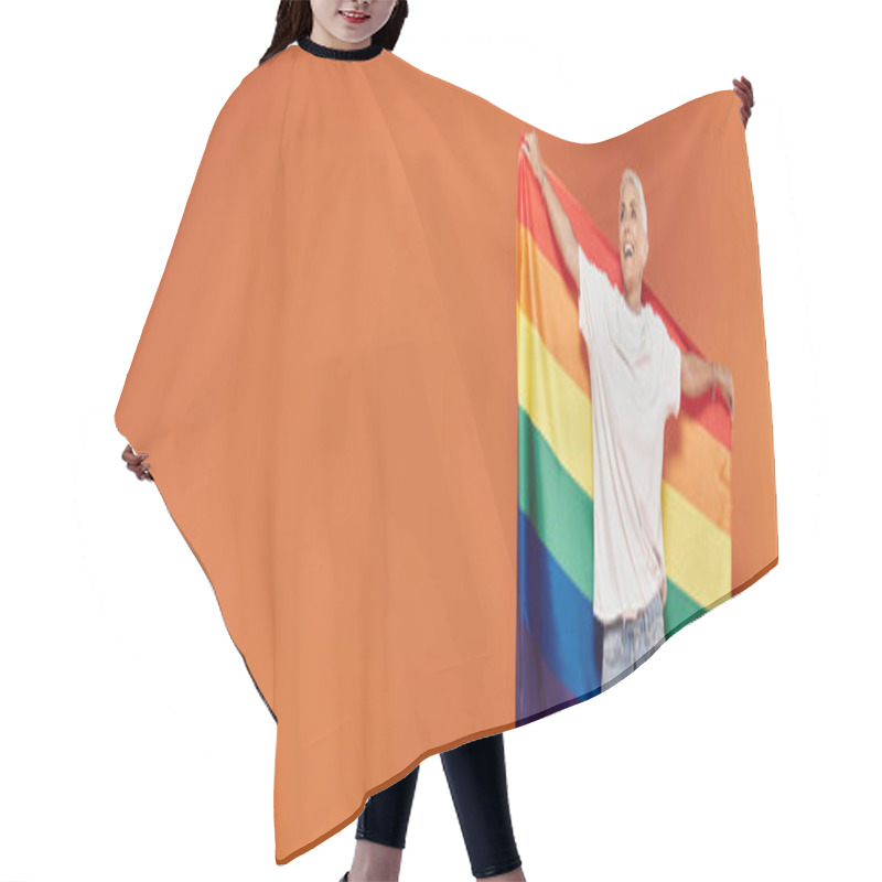 Personality  A Mature Woman Radiates Joy While Holding A Vibrant Rainbow Flag. Hair Cutting Cape