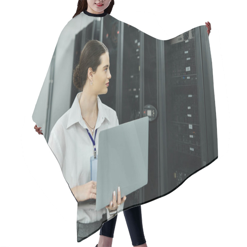 Personality  A Woman In A White Shirt Works Hard On A Laptop In A Server Room, Ensuring System Reliability. Hair Cutting Cape