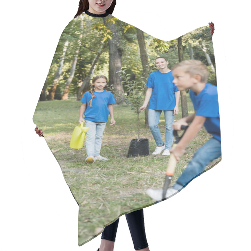 Personality  Woman With Young Tree And Daughter With Watering Can Near Boy Digging Ground With Shovel On Blurred Foreground, Ecology Concept Hair Cutting Cape