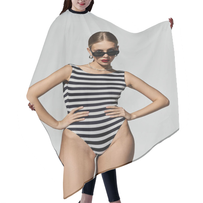 Personality  A Stylish Woman With Blonde Hair Posing In A Black And White Striped One-piece Swimsuit. Hair Cutting Cape