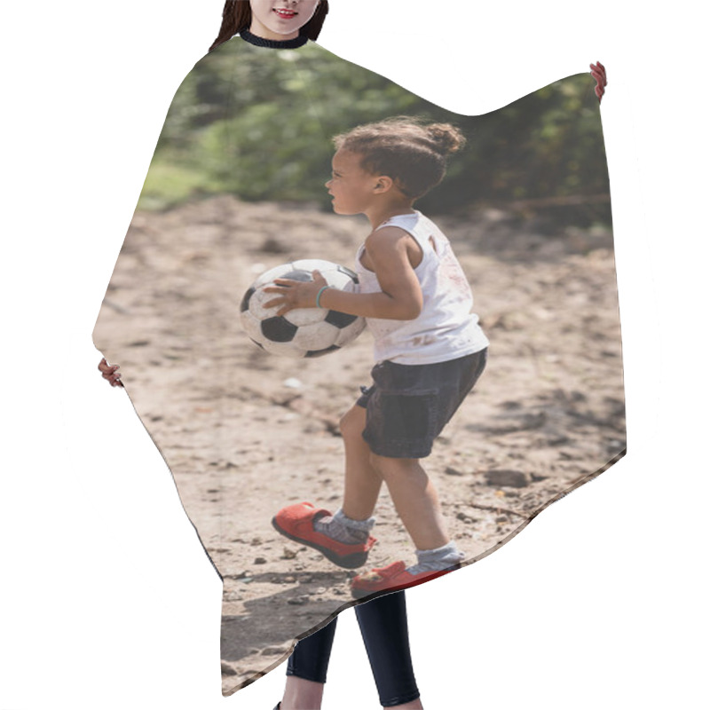 Personality  Side View Of Destitute African American Boy Holding Soccer Ball On Dirty Road In Slum  Hair Cutting Cape