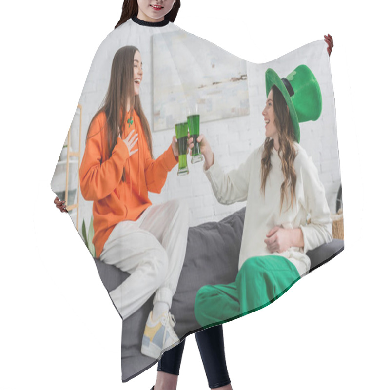 Personality  Cheerful Young Women Clinking Green Beer And Talking On Couch On Saint Patrick Day  Hair Cutting Cape