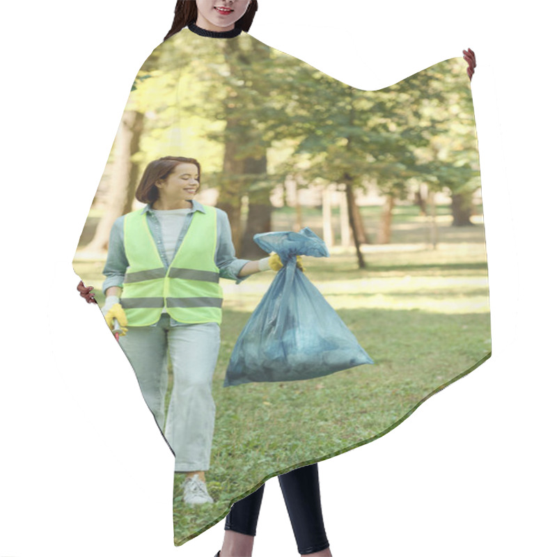 Personality  A Woman Wearing A Green Vest And Holding A Blue Bag, Standing Confidently In A Park, Possibly Ready To Clean Up Litter. Hair Cutting Cape