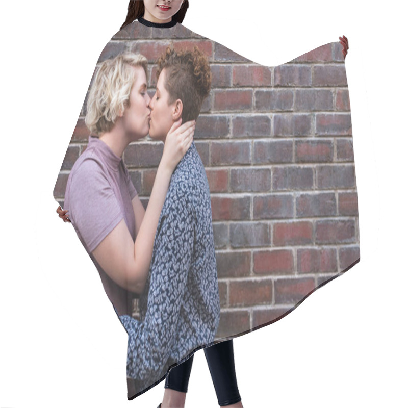 Personality  Affectionate Young Lesbian Couple Embracing And Kissing While Standing Together In Front Of A Brick Wall Outside Hair Cutting Cape