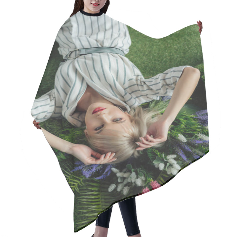 Personality  Top View Of Beautiful Stylish Girl Lying On Artificial Grass With Fern And Flowers Hair Cutting Cape