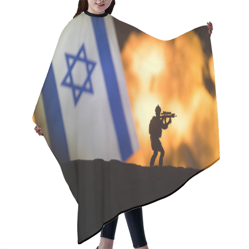 Personality  Israel Small Flag On Burning Dark Background. Concept Of Crisis Of War And Political Conflicts Between Nations. Military Fighting Silhouettes Against A Israeli Flag. Selective Focus Hair Cutting Cape