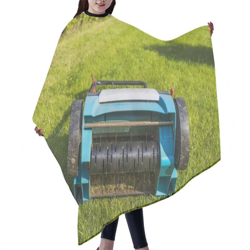 Personality  Close Up View Of Electric Lawn Aerator On Green Grass Isolated. Garden Machines Concept.  Hair Cutting Cape