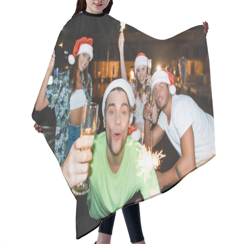 Personality  Selective Focus Of Man In Santa Hat Holding Sparkler And Glass Of Champagne Near Friends During Party At Night  Hair Cutting Cape