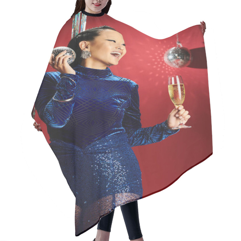 Personality  A Stylish Woman In A Blue Outfit Cheers With A Champagne Flute And Disco Ball. Hair Cutting Cape