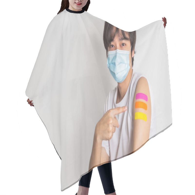 Personality  Asian Man Wearing Face Mask With A Smile On His Face Showing His Vaccinated Arm. Fight Against Virus Covid-19 Coronavirus, Vaccination And Immunization. Vaccine Booster Concept. Hair Cutting Cape