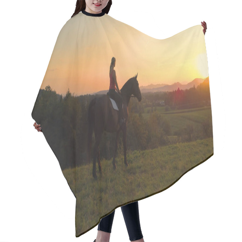 Personality  AERIAL, LENS FLARE: Flying Behind Unknown Young Girl Sitting On Her Horse And Looking At Sunrise. Unrecognizable Woman Sits On Her Horse And Observing The Picturesque Slovenian Evening Landscape. Hair Cutting Cape