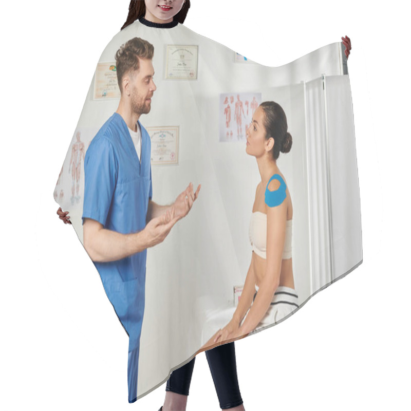 Personality  Good Looking Bearded Doctor Talking To His Young Female Patient With Kinesio Tapes On Shoulder Hair Cutting Cape