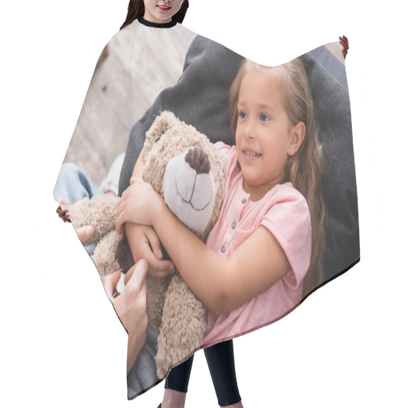 Personality  Selective Focus Of Woman Holding Stethoscope Near Daughter Embracing Teddy Bear At Home  Hair Cutting Cape