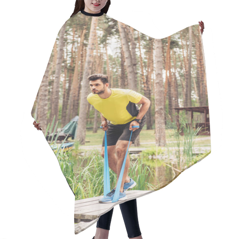 Personality  Handsome Man Exercising With Suspension Straps Near Lake In Forest  Hair Cutting Cape