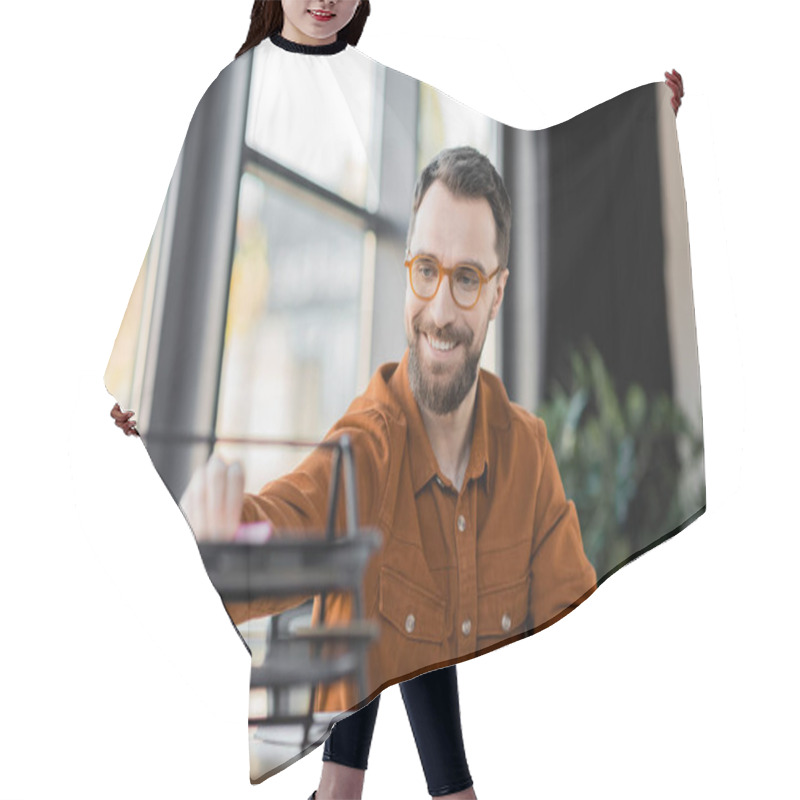 Personality  Successful And Fashionable Corporate Manager In Stylish Shirt And Eyeglasses Sitting At Workplace Near Notebook And Blurred Documents Tray At Workplace In Office Hair Cutting Cape