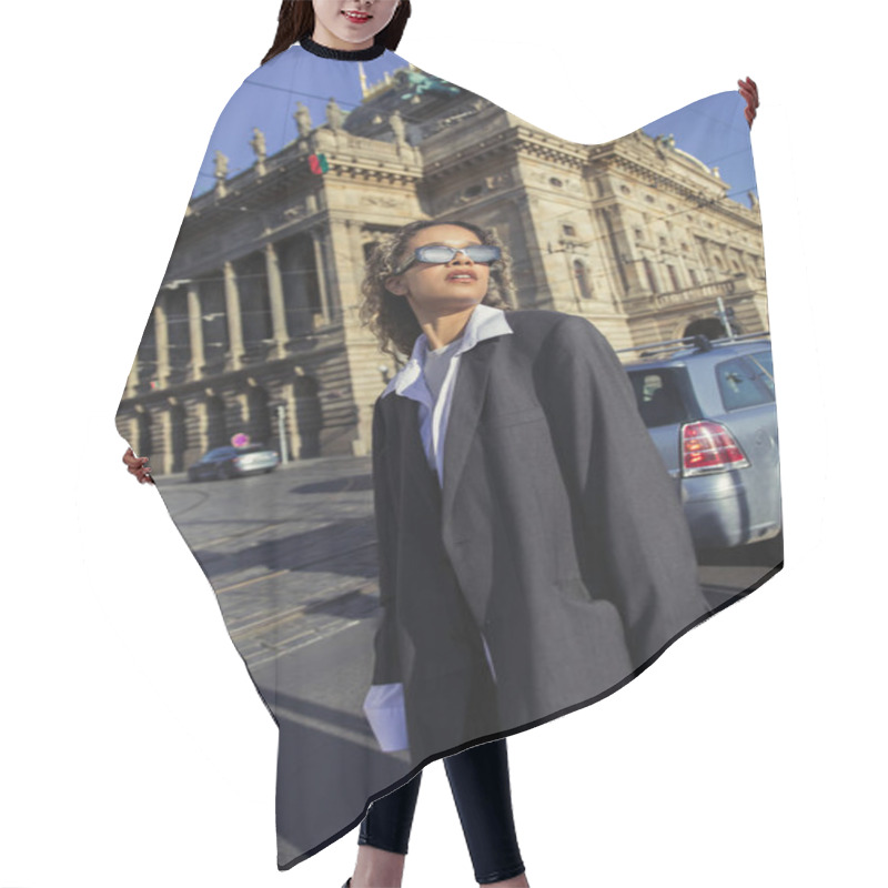 Personality  Stylish African American Woman In Oversized Blazer And Sunglasses Standing Near National Theatre In Prague Hair Cutting Cape