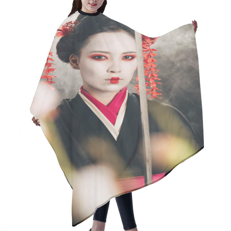 Personality  Selective Focus Of Confident Geisha In Black Kimono Holding Katana In Smoke And Sakura Branches Hair Cutting Cape