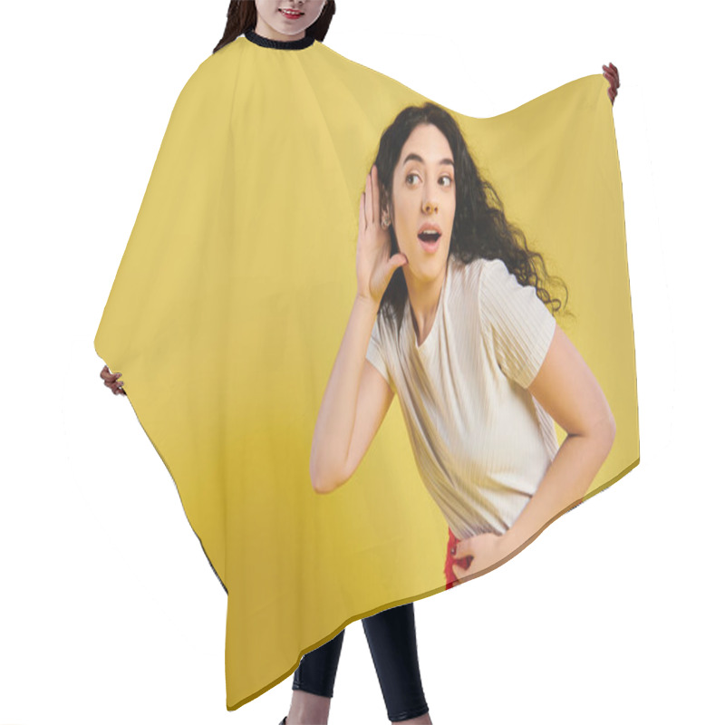 Personality  A Brunette Woman With Curly Hair Looking Surprised, Dressed In Stylish Attire, In A Studio With A Yellow Background. Hair Cutting Cape